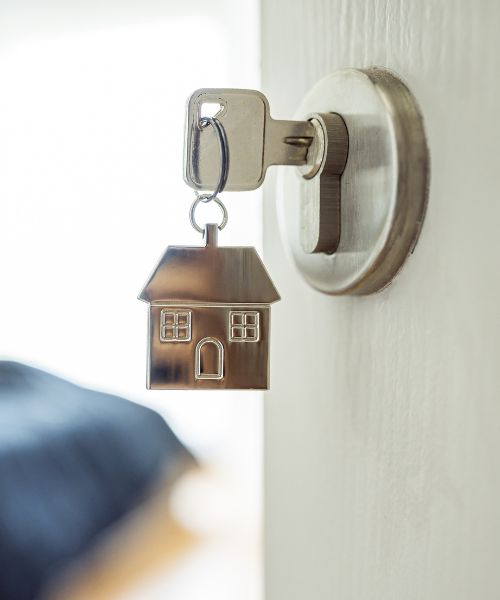 House keychain with key in door